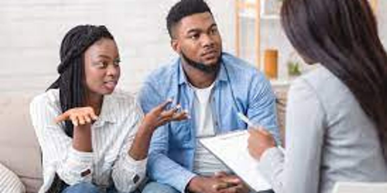 A couple discussing with a counselor or therapist in a session.