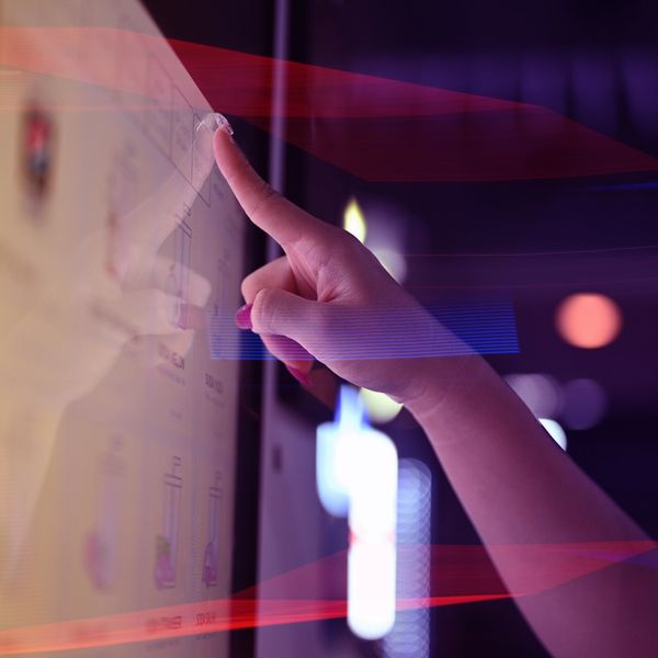 User interacting with a touchscreen display, showcasing modern digital signage and AV technology