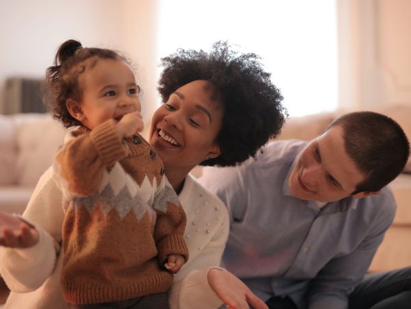 A family playing and laughing with their child