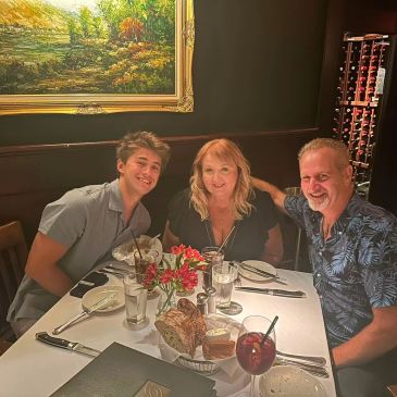 Family enjoying dinner together at a restaurant.