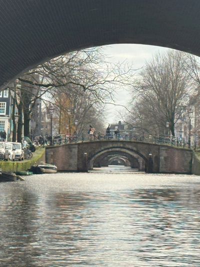 View of multiple bridges over a canal in a city.