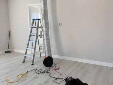 Image of Philips ventilator system connected to measure airflow from installed HVAC vent