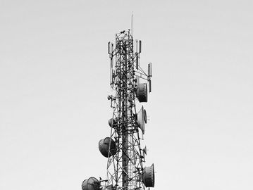 Black and white photo of a telecommunications tower.