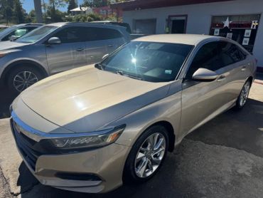 Beige sedan parked outside a building.