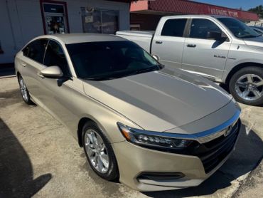 Beige Honda Accord parked outside.