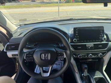 Interior view of a Honda car showing the steering wheel and dashboard.