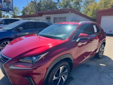 Shiny red luxury SUV parked outdoors.