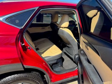 Open red car door showing beige interior seats.
