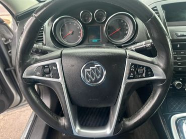Close-up of a Buick car steering wheel with controls.