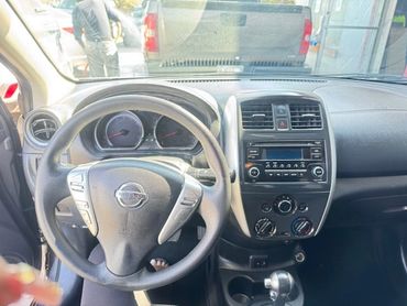 Interior of a Nissan car showing the steering wheel and dashboard.