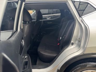 Interior view of a car's backseat with the door open.