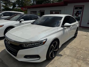 White Honda sedan parked outdoors.