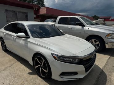 Two white vehicles parked next to each other.