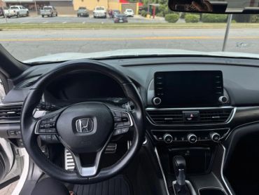 Interior view of a Honda car dashboard and steering wheel.
