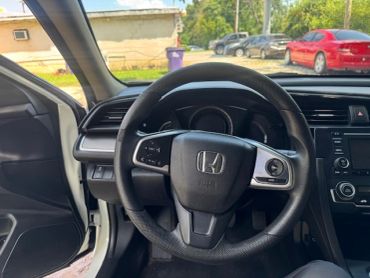 Interior view of a Honda car steering wheel.
