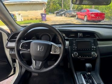 Interior view of a Honda car dashboard and steering wheel.