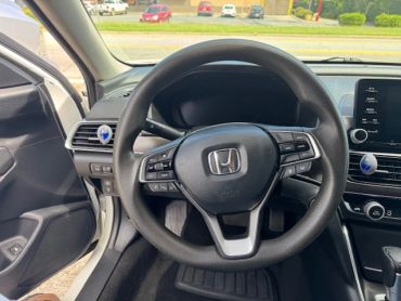 Steering wheel of a Honda car interior.