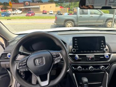 Interior view of a Honda car dashboard and steering wheel.