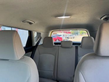 Interior of a car showing back seats and front seats.