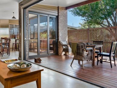 Cozy indoor-outdoor living space with wooden deck and seating area.
