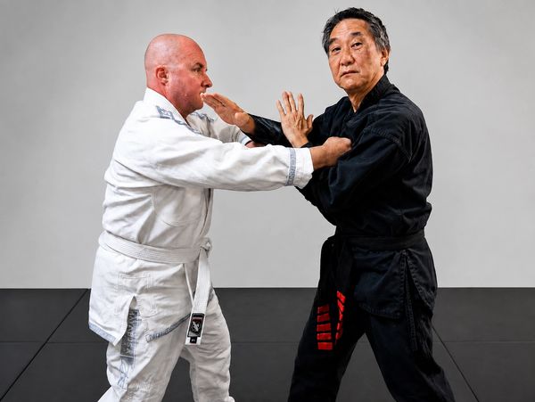 Two men practicing martial arts in gis.