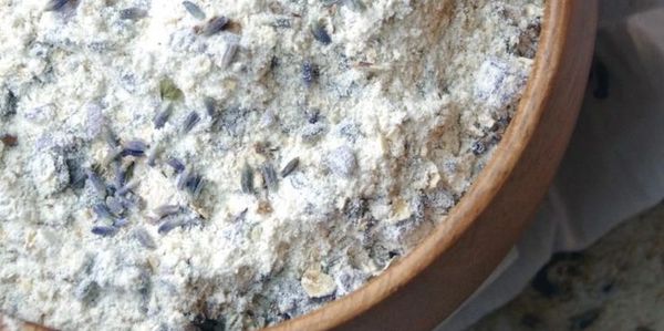 Close-up of a bowl filled with flour and lavender buds.