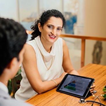 Woman showing a tablet with a presentation to a colleague.