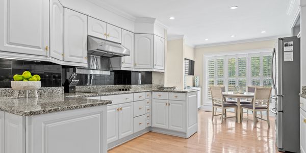 Updated kitchen with granite counter tops, stainless steel appliances and wood floors