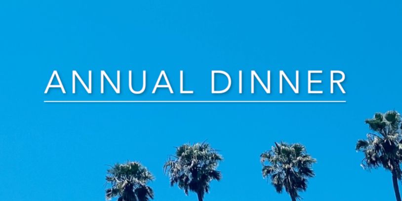Text 'Annual Dinner' with palm trees under a clear blue sky.