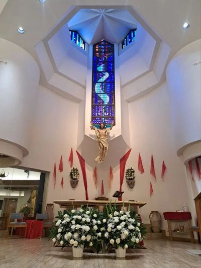 Photo of church nave with white flowers