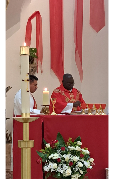 Father Uju at the altar, helped by Deacon Ramirez on Pentecost Sunday.