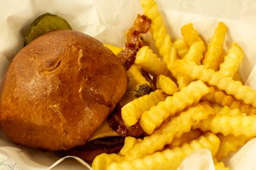 A crispy bacon cheeseburger with crinkle-cut fries.
