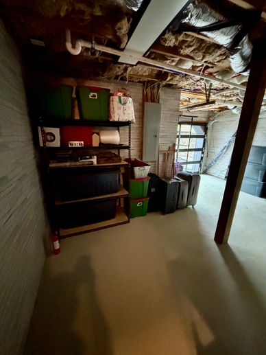 Organized basement storage with boxes and suitcases.
