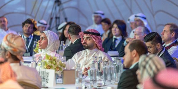Audience attentively listening at a formal event.