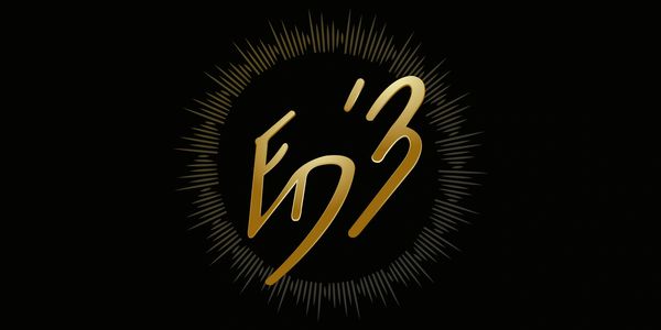 Elegant golden symbol with radiant spikes on a black background.