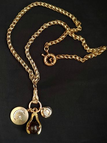 Handmade lucky 'knock on Wood' necklace. Upcycled star & moon, hands, on heavy chain.
Brass.
Etsy 