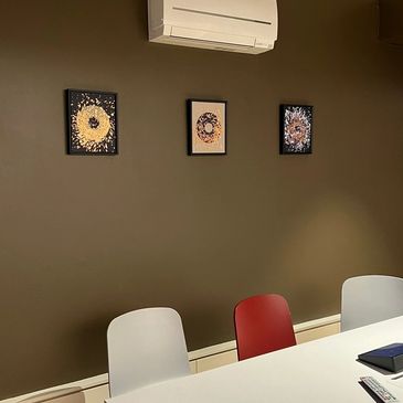 Trio of work by Caroline Banks on display in an office meeting room