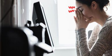 Person experiencing dry eye symptoms and eye discomfort while using a computer.