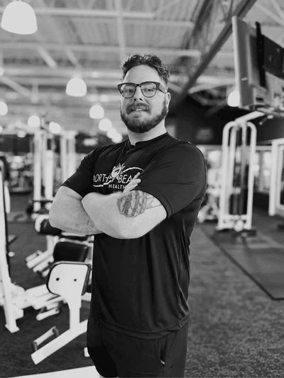 Man posing confidently in a gym.
