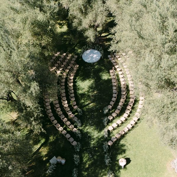 Outdoor wedding ceremony surrounded by olive trees at Hummingbird Nest Ranch in Santa Susana, California.