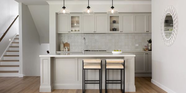 Modern kitchen with island and pendant lights.