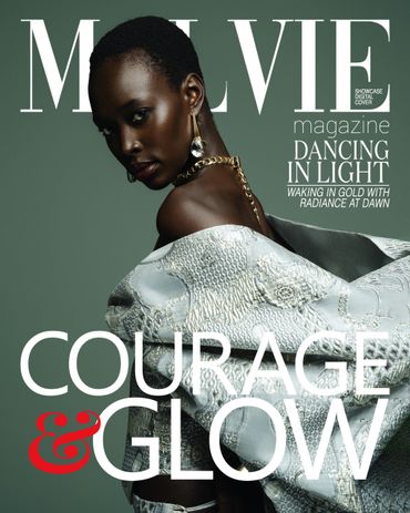 Fashion magazine cover featuring a striking model with glowing skin and elegant attire.