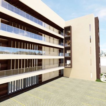 Edificio moderno con balcones de vidrio y un amplio estacionamiento.
