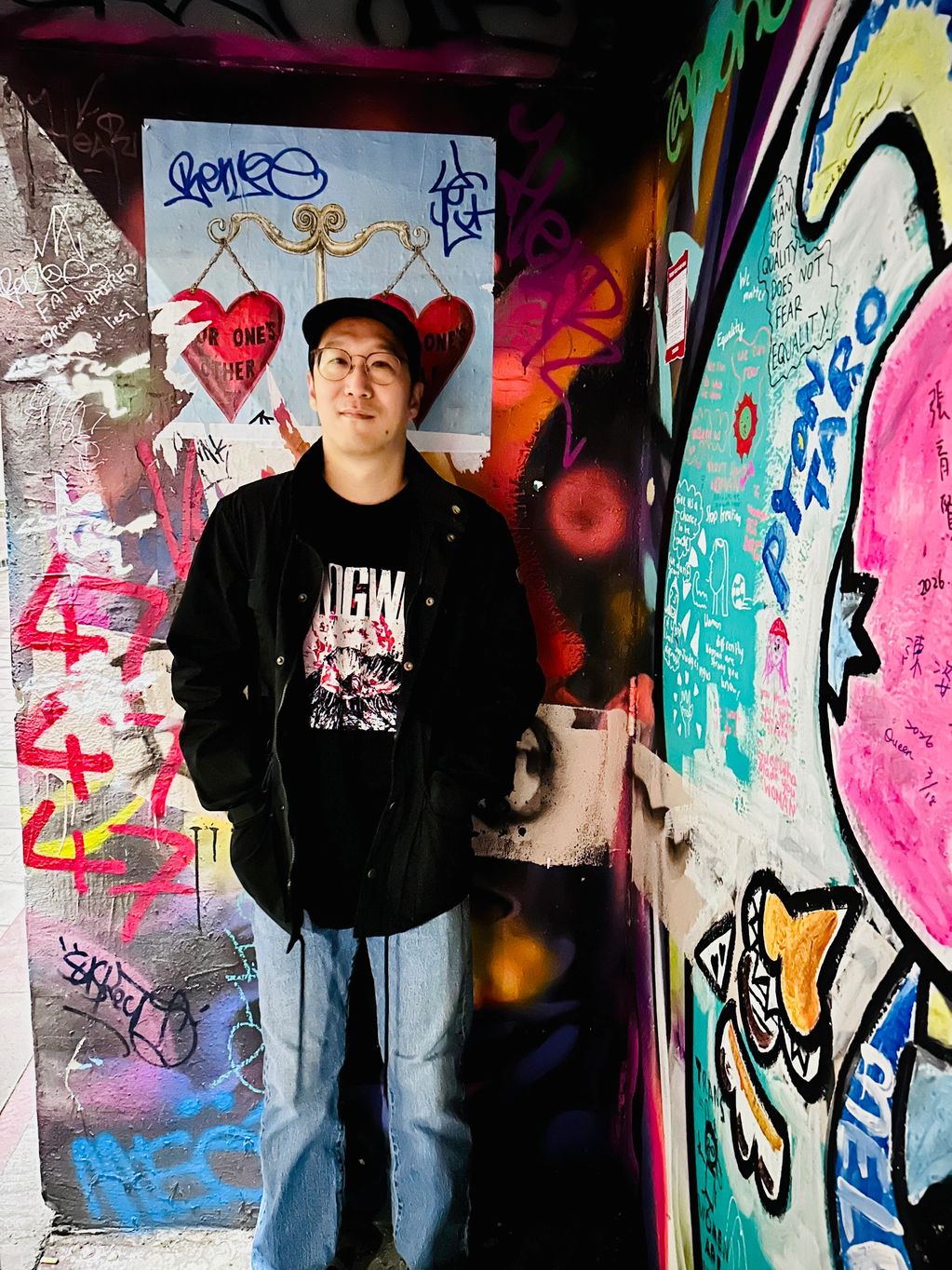 man in front of street art