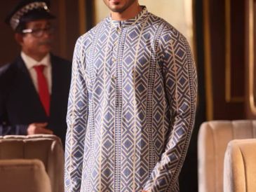 Man wearing a patterned traditional outfit.