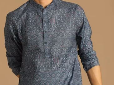 Man wearing a blue printed kurta with rolled-up sleeves.