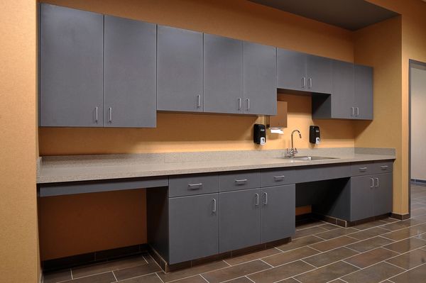 Modern kitchenette with sleek gray cabinets