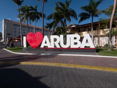 A large sign with a red heart and the word "ARUBA" under palm trees.