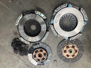 Two used clutch kits with discs and pressure plates.
