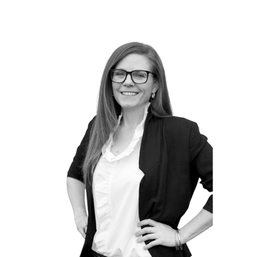 Smiling woman in glasses with hands on hips.